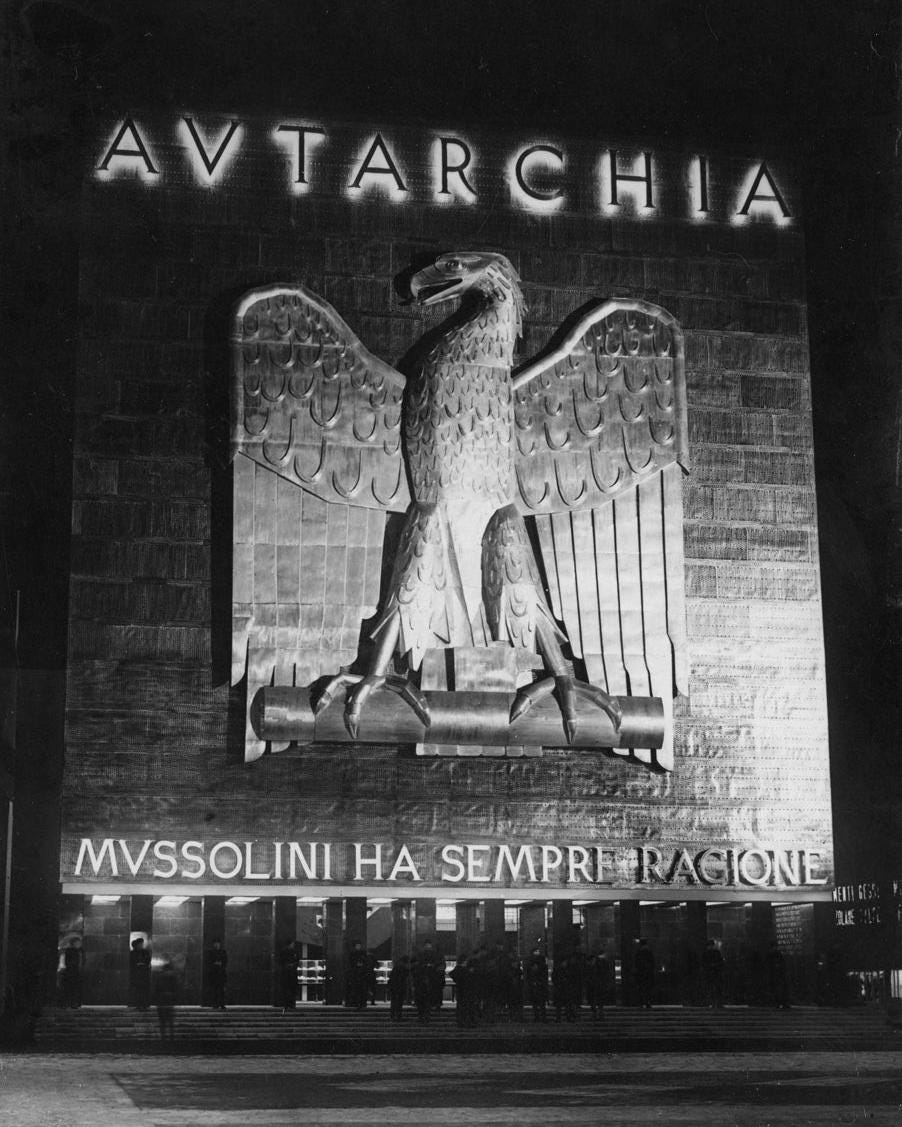 The slogan 'Mussolini is always right' displayed at the entrance of Italy's autarky exhibition in Rome, 1938, a testament to Fascist propaganda. The slogan 'Mussolini is always right' displayed at the entrance of Italy's autarky exhibition in Rome, 1938, a testament to Fascist propaganda.