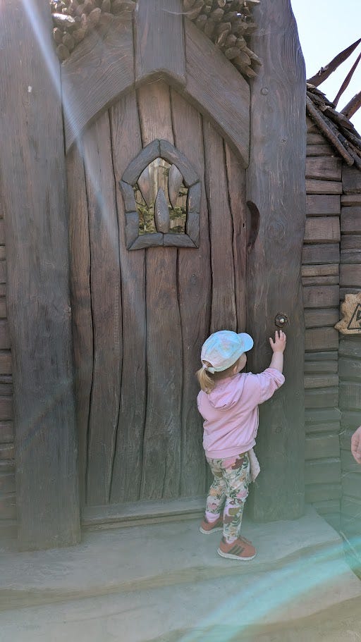 Left photo shows a toddler pressing a doorbell on a wooden cottage, the right photo is of Lilidorei, a fantasy-inspired play structure with ladders, bridges and slides.