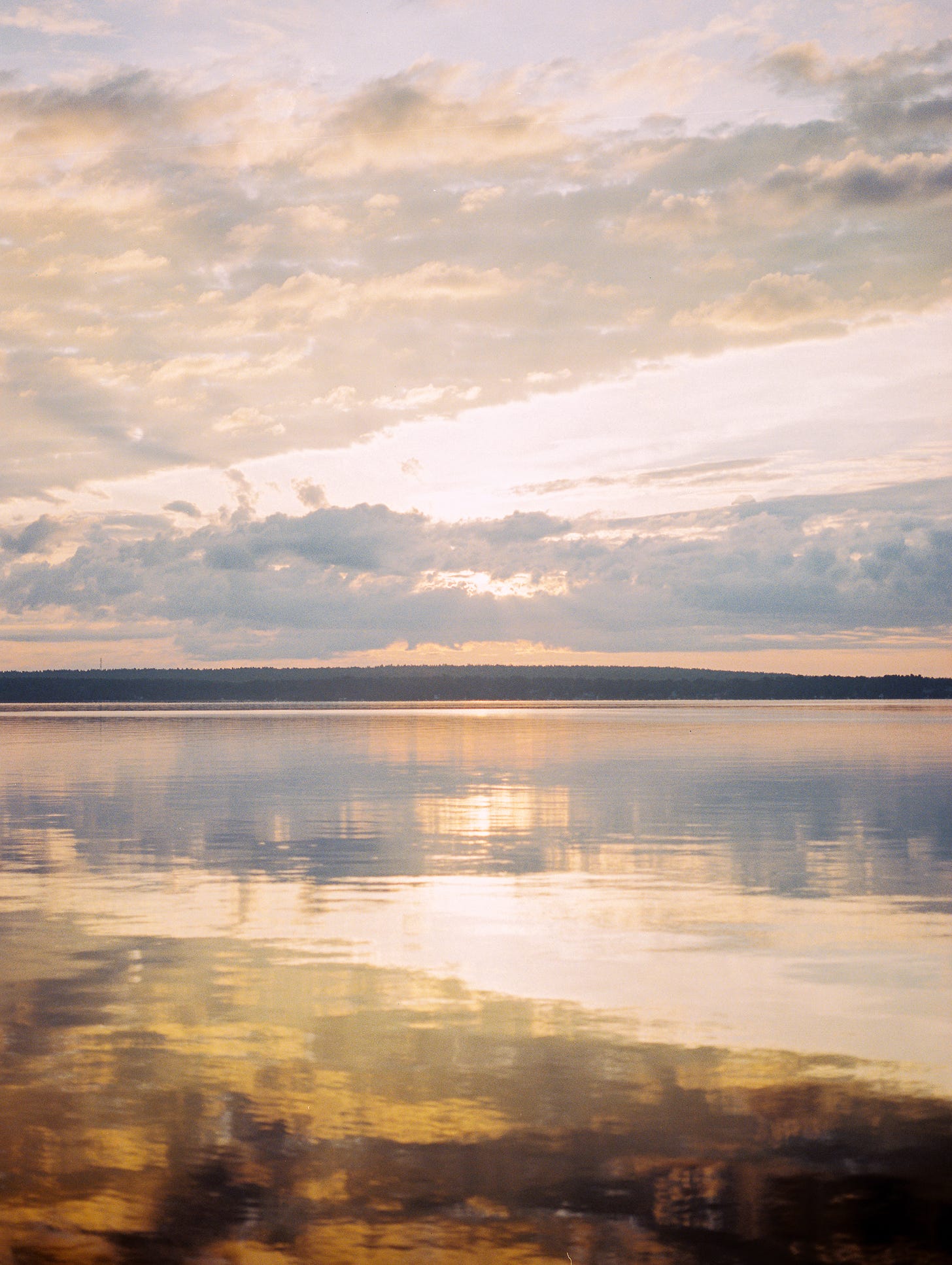 Photo of clouds over a lake at sunrise