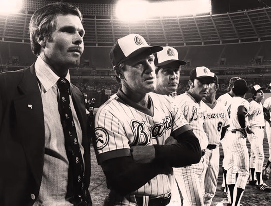 Ted Turner and Dave Bristol stand on the field at Atlanta-Fulton County Stadium.