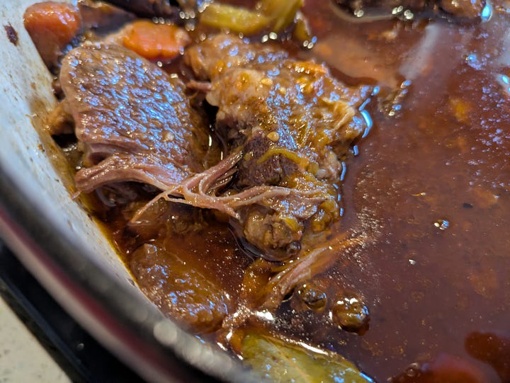 Braised beef with oxtail and veggies showing meat consistency and adding a few fresher veggies near the end of the process for brighness.