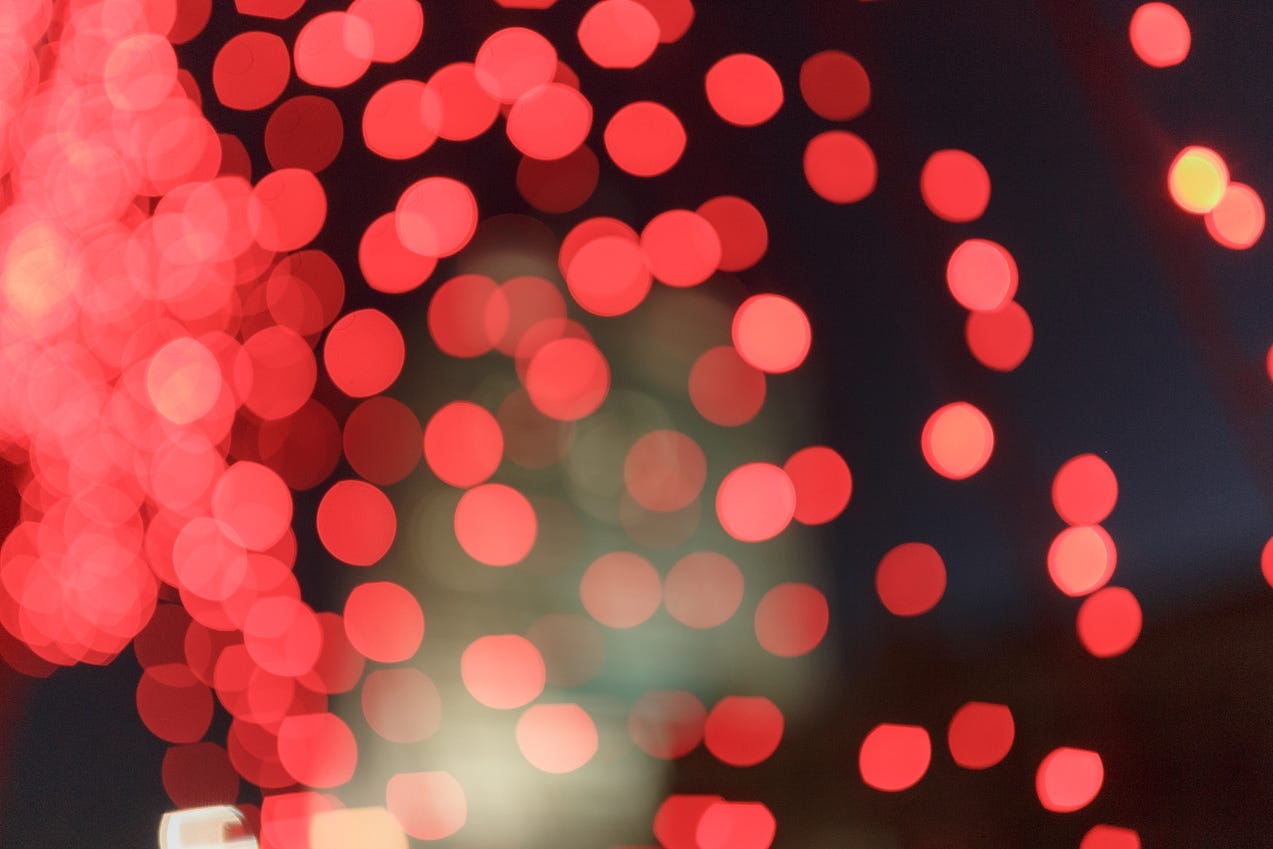 Red dots of light on a black background
