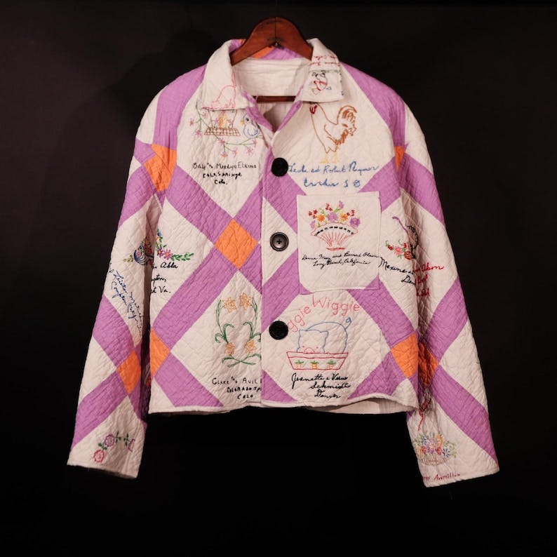 May include: A quilted jacket in purple, orange, and white features embroidered designs and handwritten names.  The diamond-patterned patchwork includes various embroidered images, such as a rooster, flowers, and a pig.  Names and locations are stitched onto the fabric.  The jacket has a collared neckline and button closure.