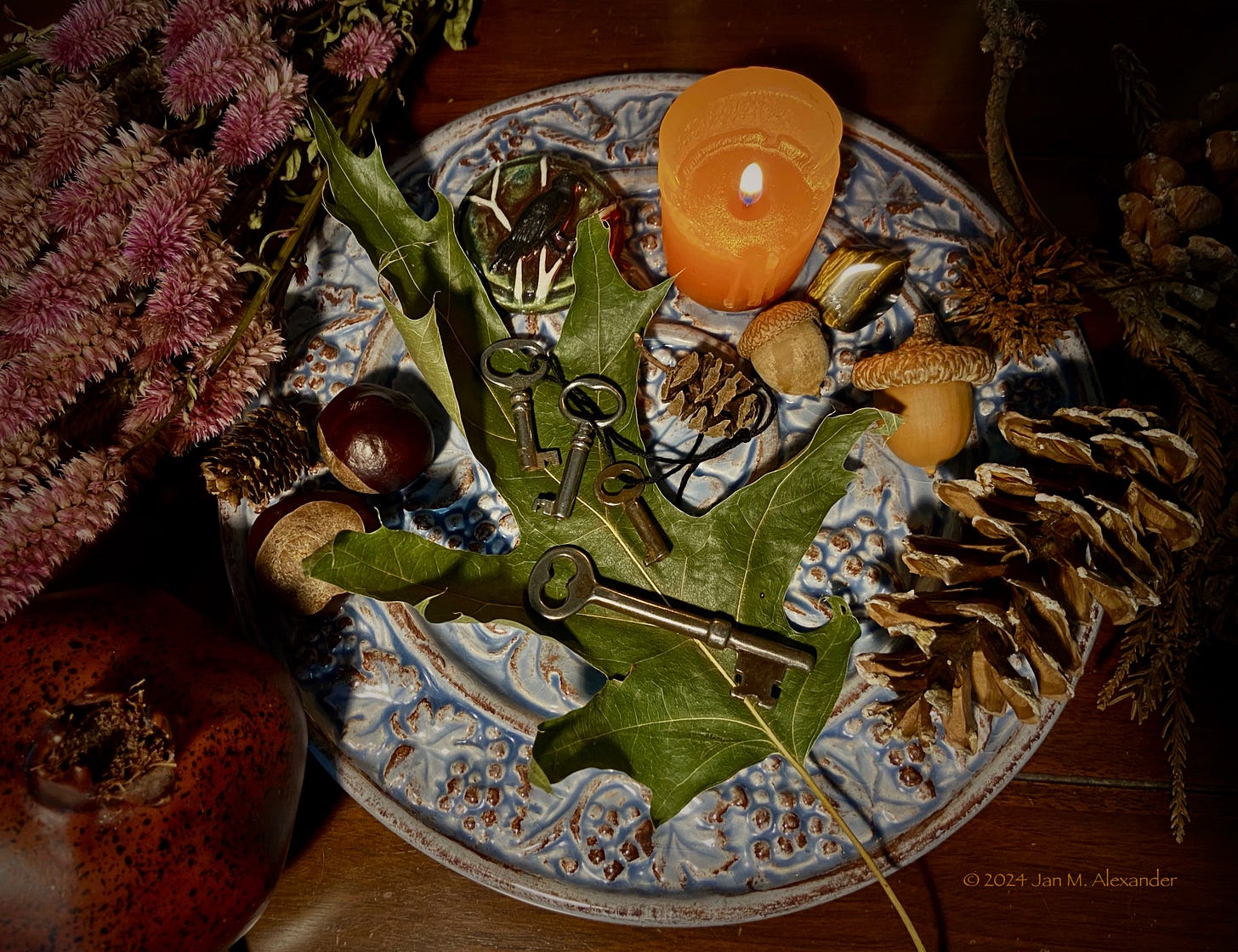 Keys with candle and pinecones.
