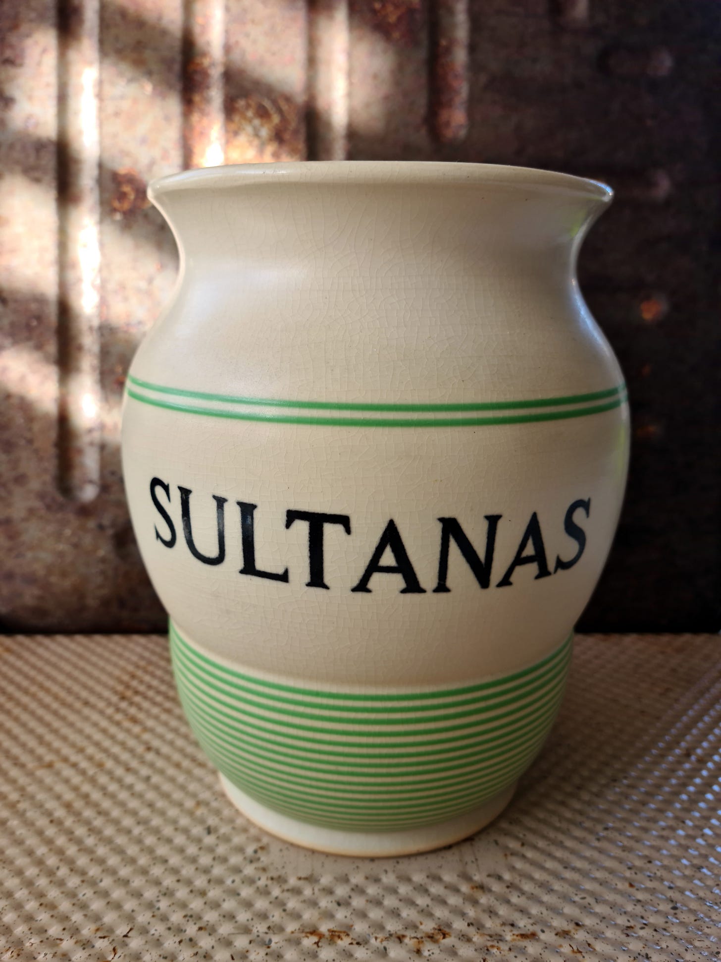A large curvy vintage jar with SULTANAS written across the middle.