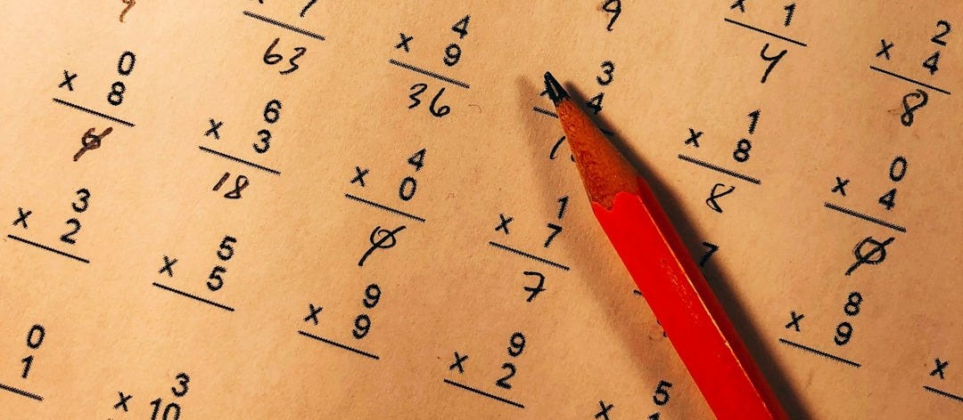 red pencil on top of mathematical quiz paper red pencil on top of mathematical quiz paper