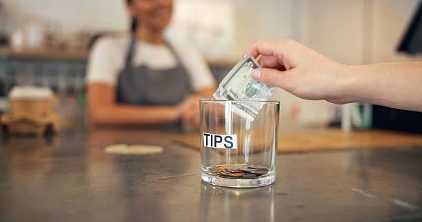 Person, hands and bills for tips at cafe for service excellence, gratitude or kind gesture on countertop. Closeup, shopper or customer with dollar, money or cash in glass for payment or contribution Person, hands and bills with tips at cafe for service excellence, gratitude or kind gesture on countertop. Closeup, shopper or customer with dollar, money or cash in glass for payment or contribution No Tax on Tips stock pictures, royalty-free photos & images Person, hands and bills for tips at cafe for service excellence, gratitude or kind gesture on countertop. Closeup, shopper or customer with dollar, money or cash in glass for payment or contribution Person, hands and bills with tips at cafe for service excellence, gratitude or kind gesture on countertop. Closeup, shopper or customer with dollar, money or cash in glass for payment or contribution No Tax on Tips stock pictures, royalty-free photos & images