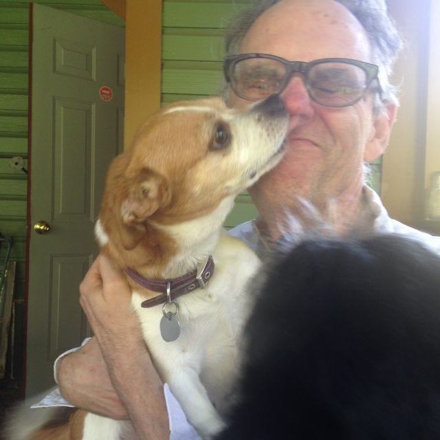My dad, being licked aggressively by Joe the Dog, on the back porch of their house