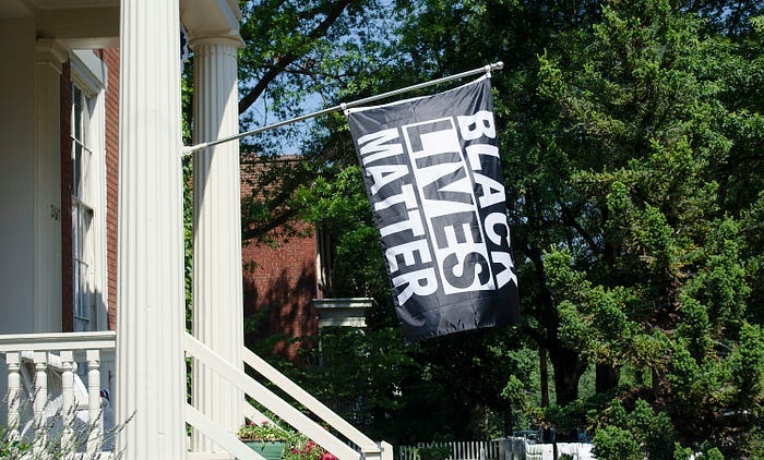A Black Lives Matter flag flying outside a home. Corporations often sell merchandise that hits at an emotional core for the consumer. A Black Lives Matter flag flying outside a home. Corporations often sell merchandise that hits at an emotional core for the consumer.