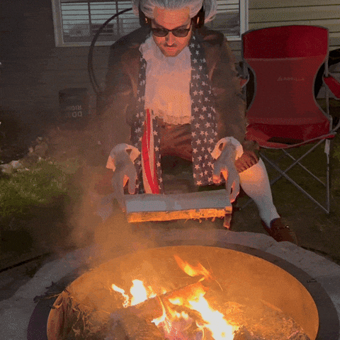 Man dressed as a founding father dramatically burning documents over a fire pit—used in Beating the Tide newsletter to humorously depict political volatility, reactionary policies, or over-the-top market reactions.