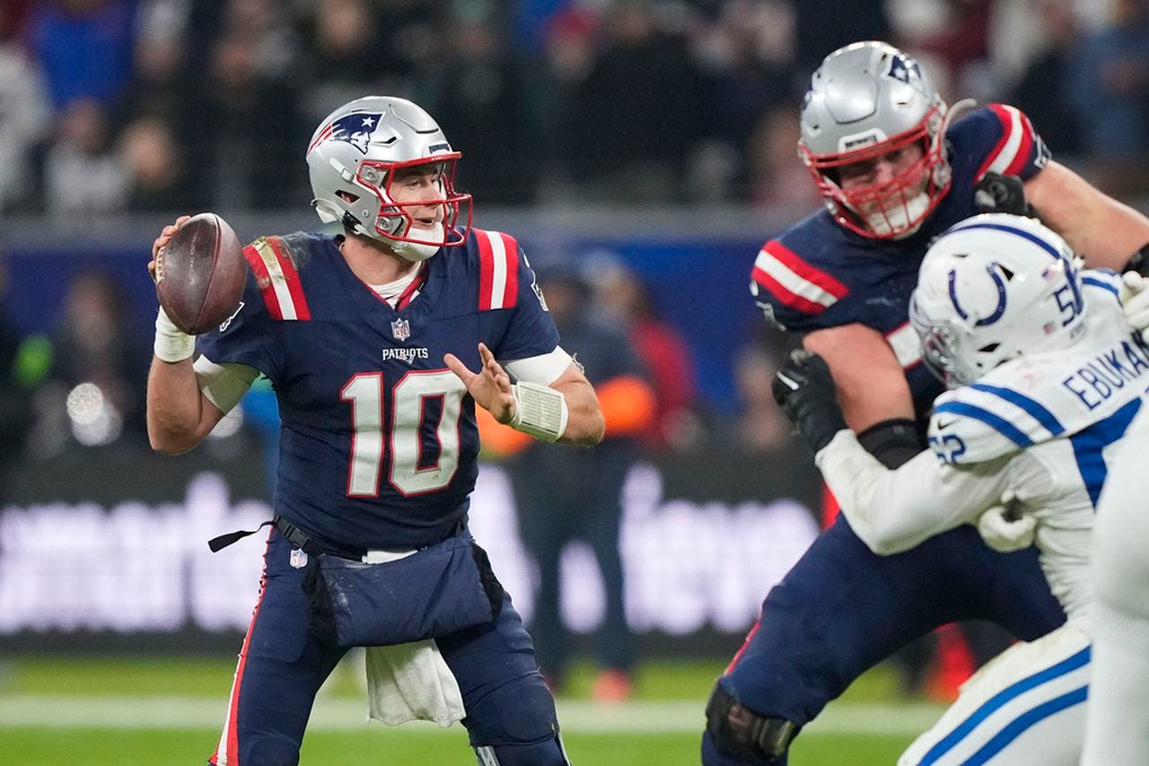 New England Patriots quarterback Mac Jones works in the pocket during an NFL game against the Indianapolis Colts