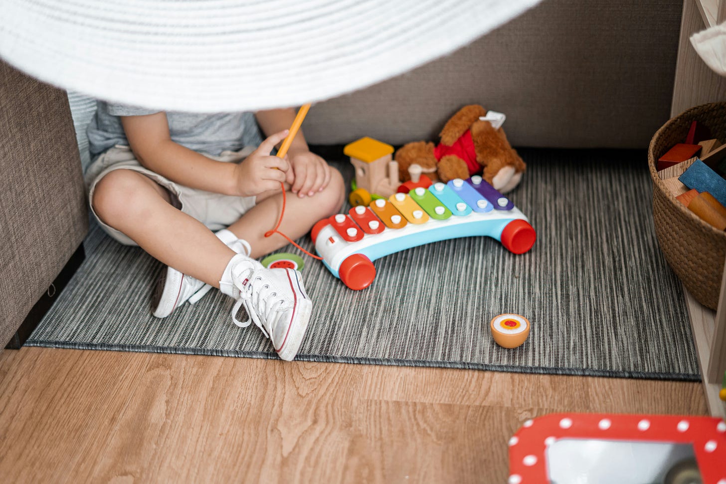a child playing a toy xylophone