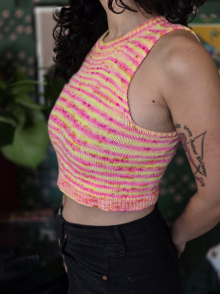 Various knitted projects including a shawl, two tank tops, a mini skirt, two sweaters, and an off the shoulder top