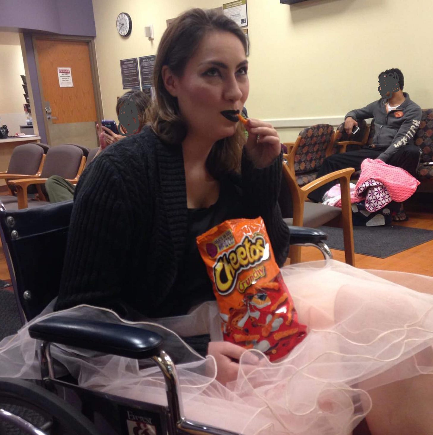 Shell wearing black lipstick, a black sweater, and a tutu, eating cheetos in the emergency room. Shell wearing black lipstick, a black sweater, and a tutu, eating cheetos in the emergency room.