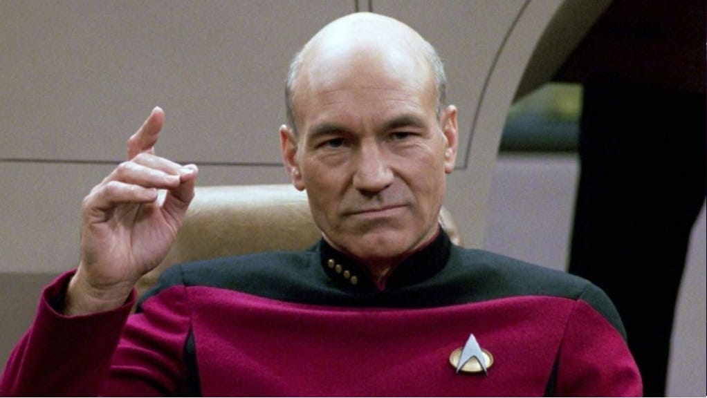 Screenshot of Patrick Stewart as Captain Picard, holding up right hand and pointing as he's about to say 'Engage.' Screenshot of Patrick Stewart as Captain Picard, holding up right hand and pointing as he's about to say 'Engage.'