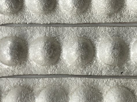 silver textured with stones and press formed to resemble pearls