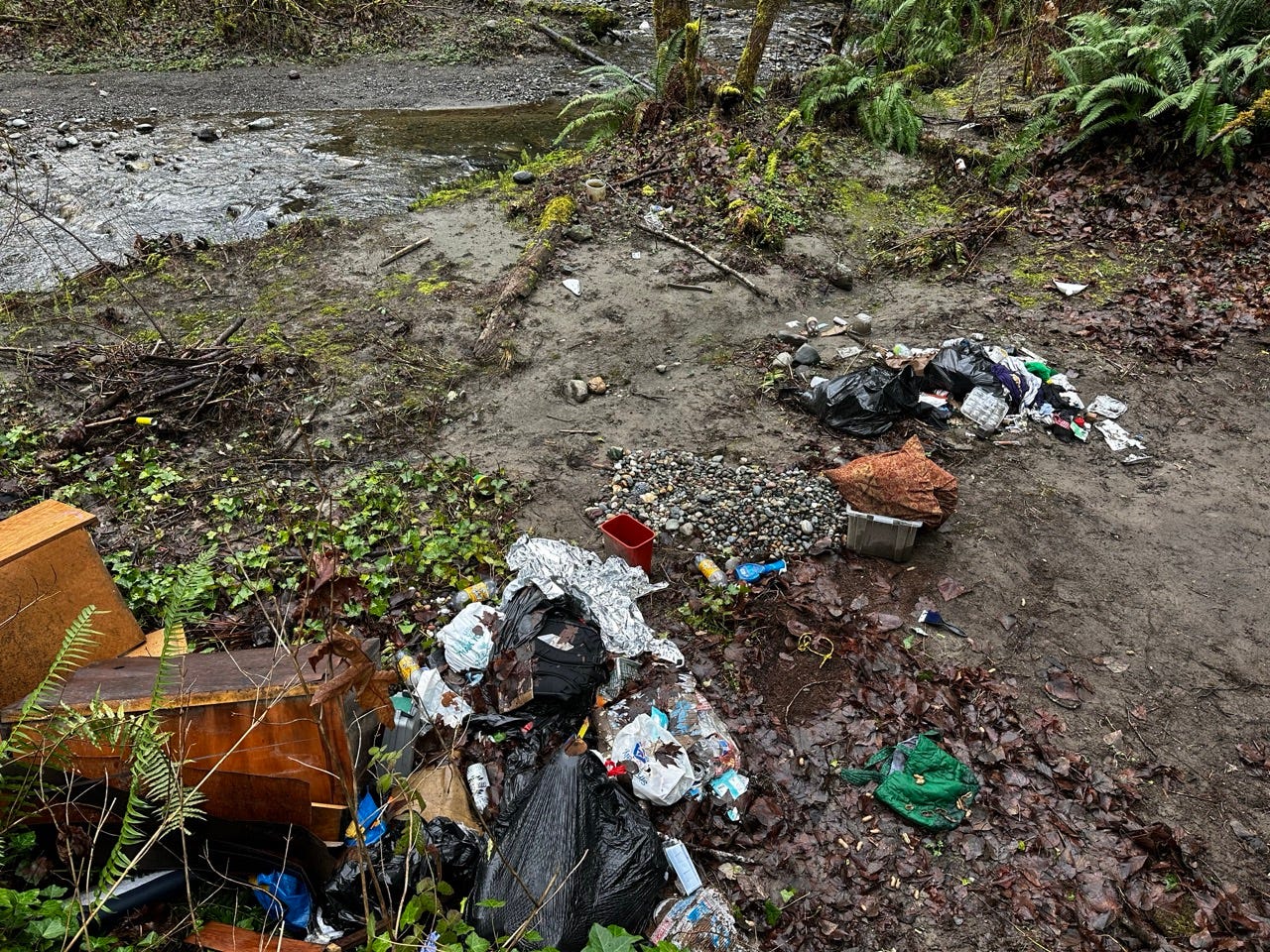 A dirty area with trash and water

Description automatically generated with medium confidence