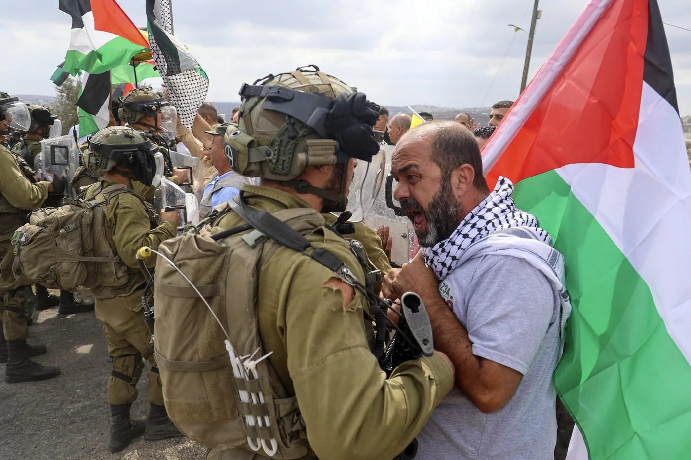 A Palestinian demonstrator confronts “Israeli” security forces during a protest against the expropriation of Palestinian land by “Israel” in the village of Kfar Qaddum in the occupied West Bank, on October 7th, 2022.