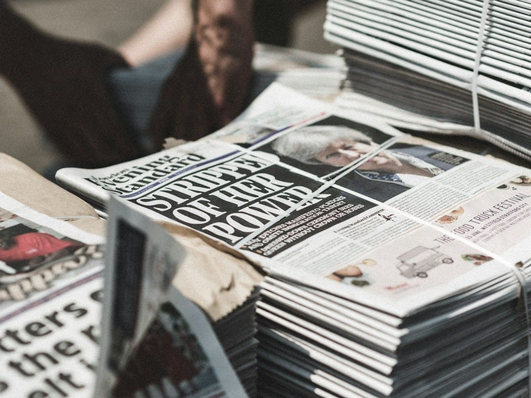 shallow focus photography of piles of newspapers shallow focus photography of piles of newspapers
