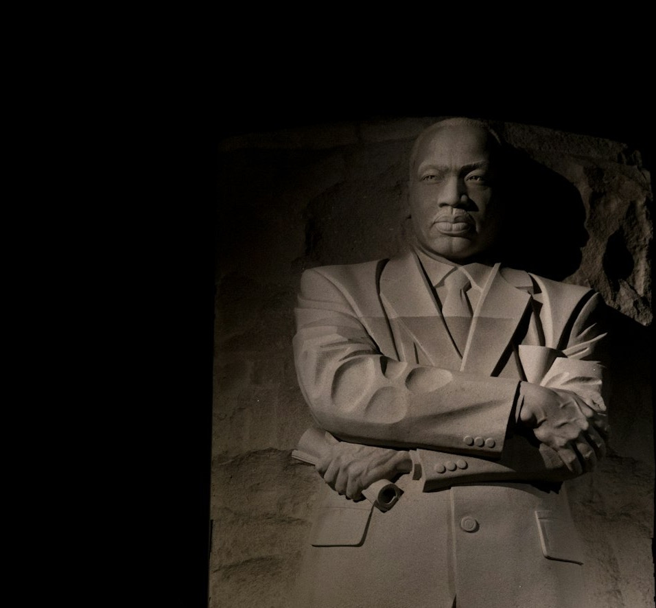 a black and white photo of a man in a suit