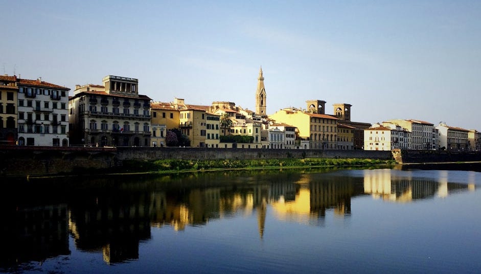 beige buildings near large body of water beige buildings near large body of water