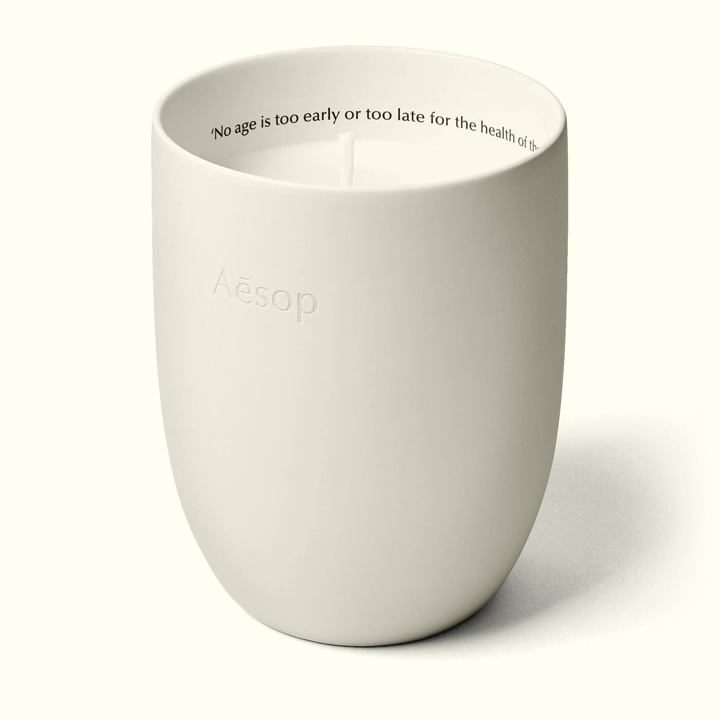 Aesop Ptolemy scented candle in a minimalist off-white ceramic vessel with embossed branding. Aesop Ptolemy scented candle in a minimalist off-white ceramic vessel with embossed branding.