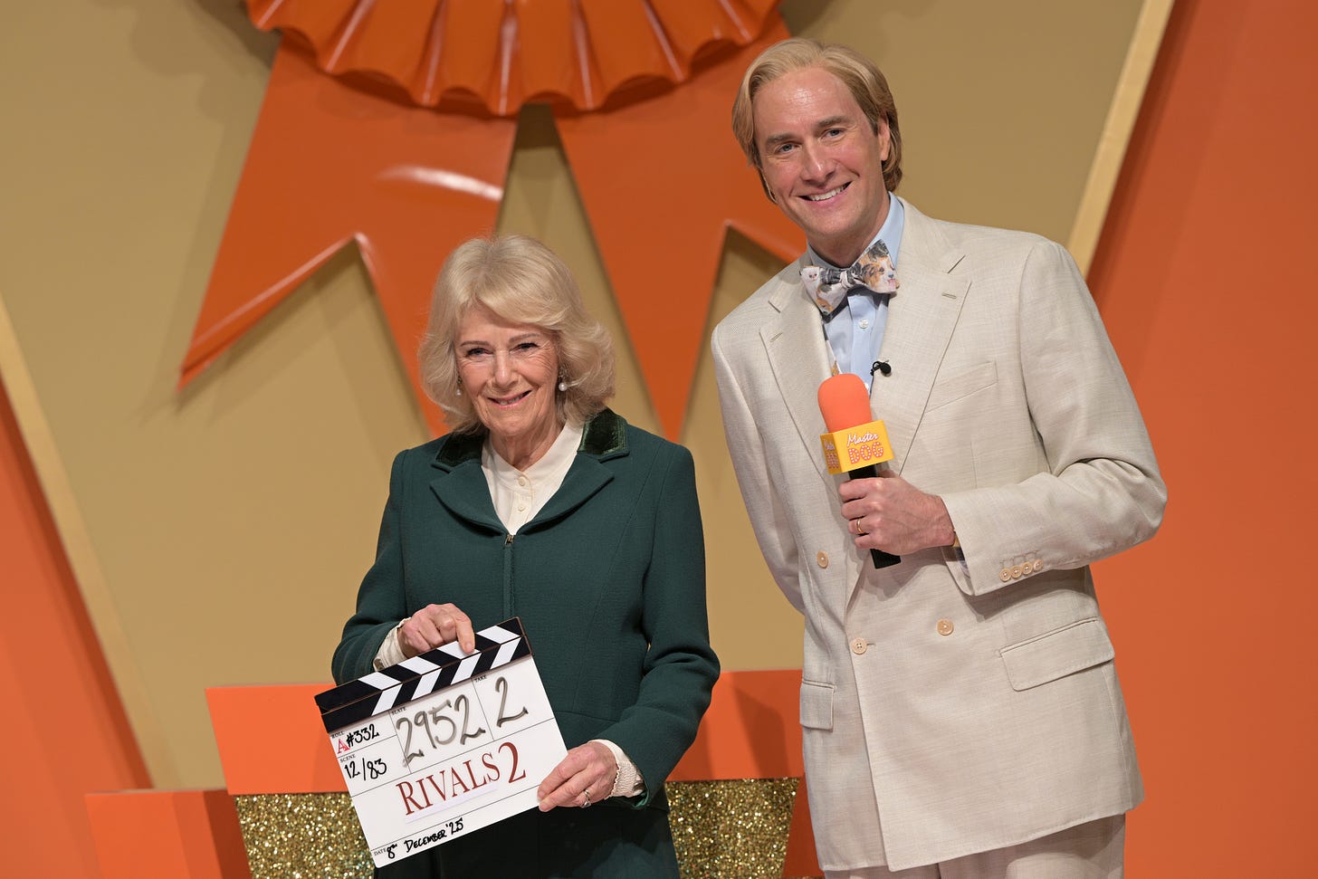 Queen Camilla holding a clapper board