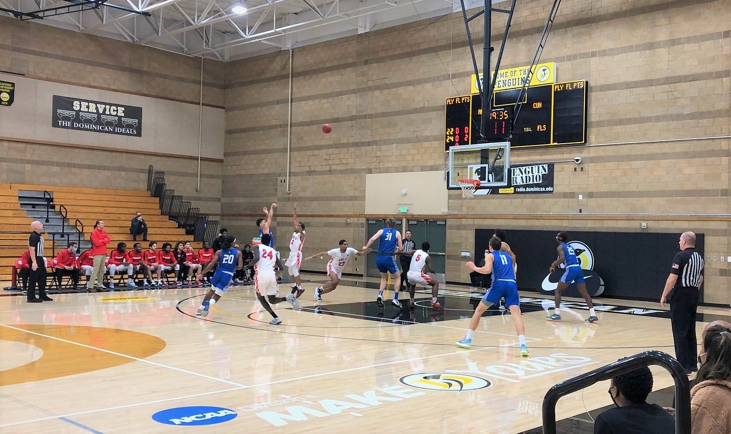 Chaminade (in blue) shooting a jumper against Academy of Art U (in whi Chaminade (in blue) shooting a jumper against Academy of Art U (in whi