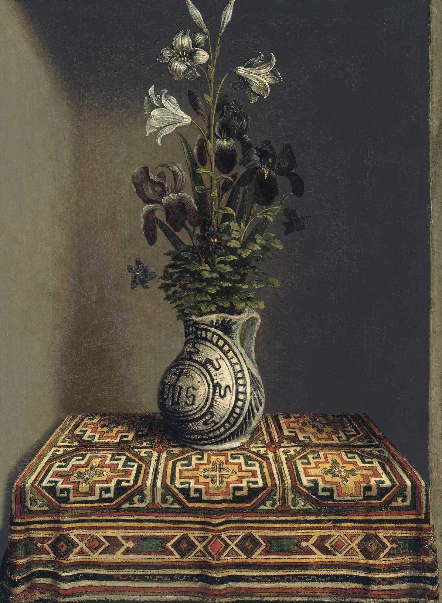 Lilies and irises in a majolica jug on an Oriental rug