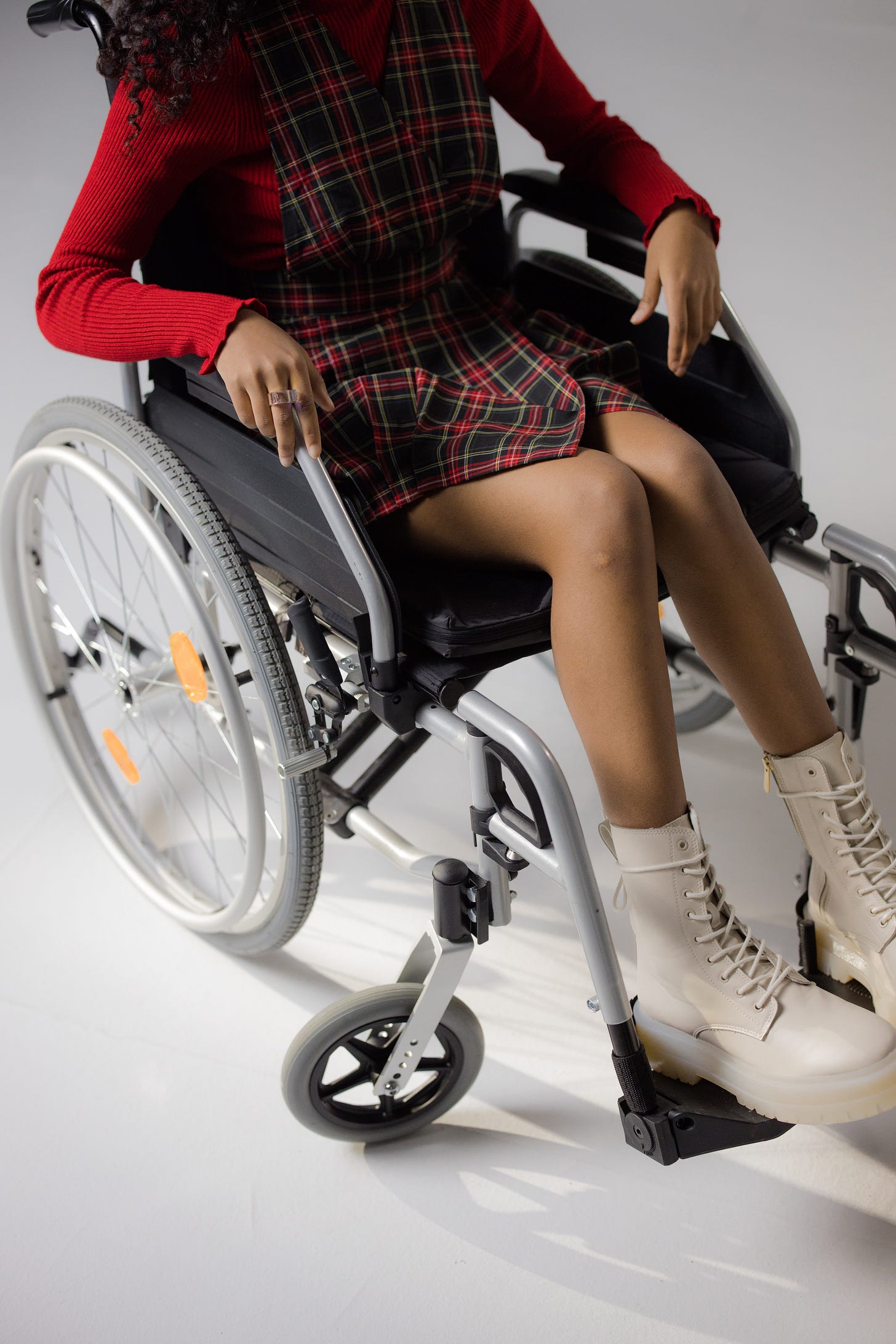 Woman in a short dress in a far too big wheelchair