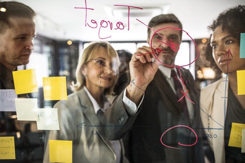 Man writes on glass wall