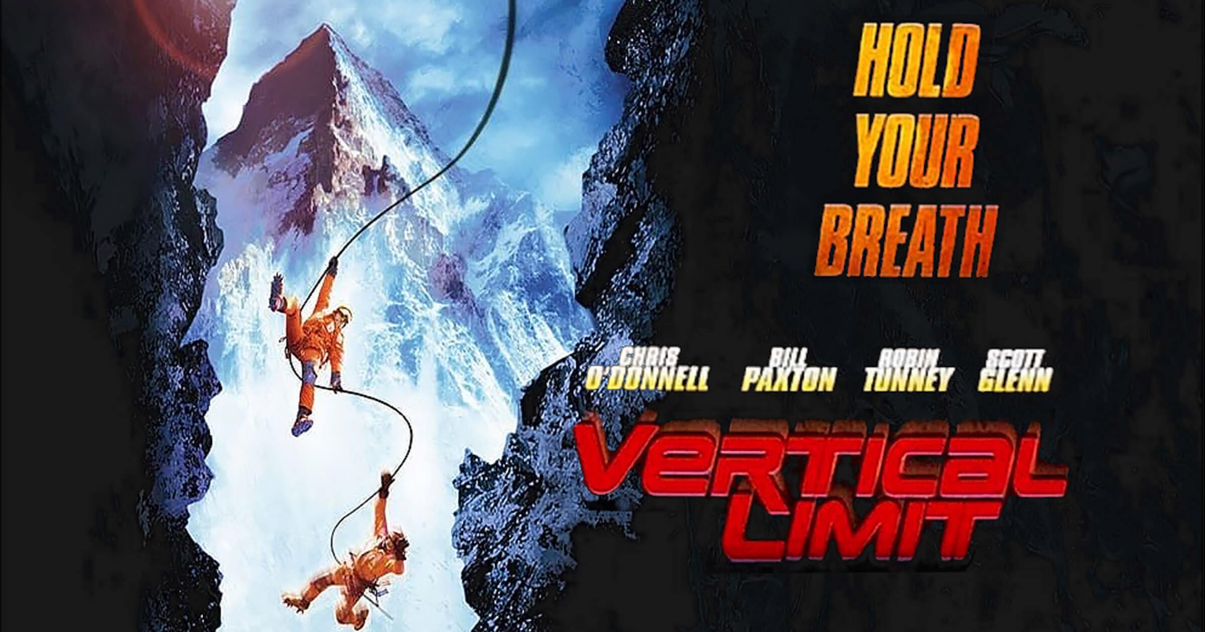 Poster for Vertical Limit (2000), showing two climbers suspended by rope between jagged cliff faces, with a towering snow-covered mountain in the background. The tagline reads “Hold Your Breath” in bold yellow and orange text, with actor names listed above the red title logo.