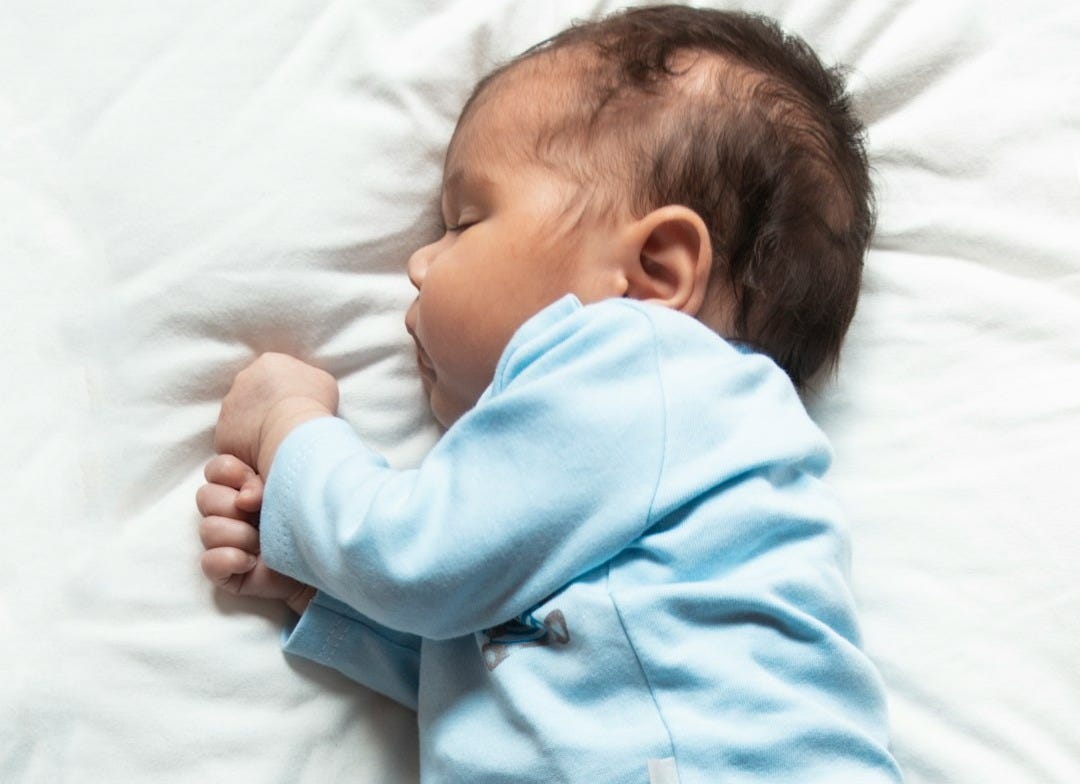 woman in teal pajama lying on bed woman in teal pajama lying on bed