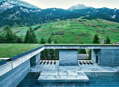 Interior of Therme Vals thermal baths by Peter Zumthor, Vals, Switzerland. Dark quartzite stone walls and thermal water pools lit by natural light from above. Architecture by Peter Zumthor.