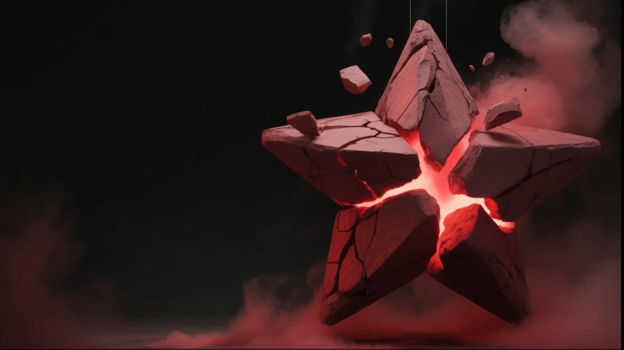 A cracked red stone star suspended in darkness, glowing with red light from internal fractures as debris floats outward.