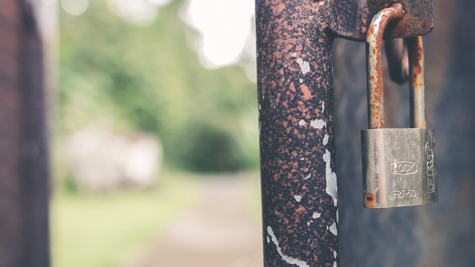 A door and a lock ajar with a hazy green background