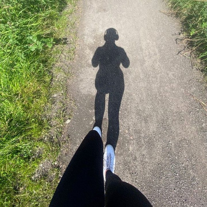 running outdoors in comfortable athletic gear during a sunny morning jog.