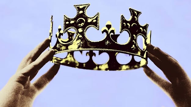 someone holding a gold kings crown