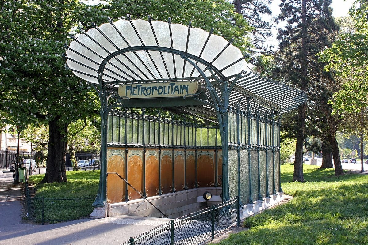 Photo of an entrance to the Paris Metro in the ornate Art Nouveau style. Photo by Bellomonte - Own work, CC0, via [Wikimedia](https://commons.wikimedia.org/w/index.php?curid=24717057)