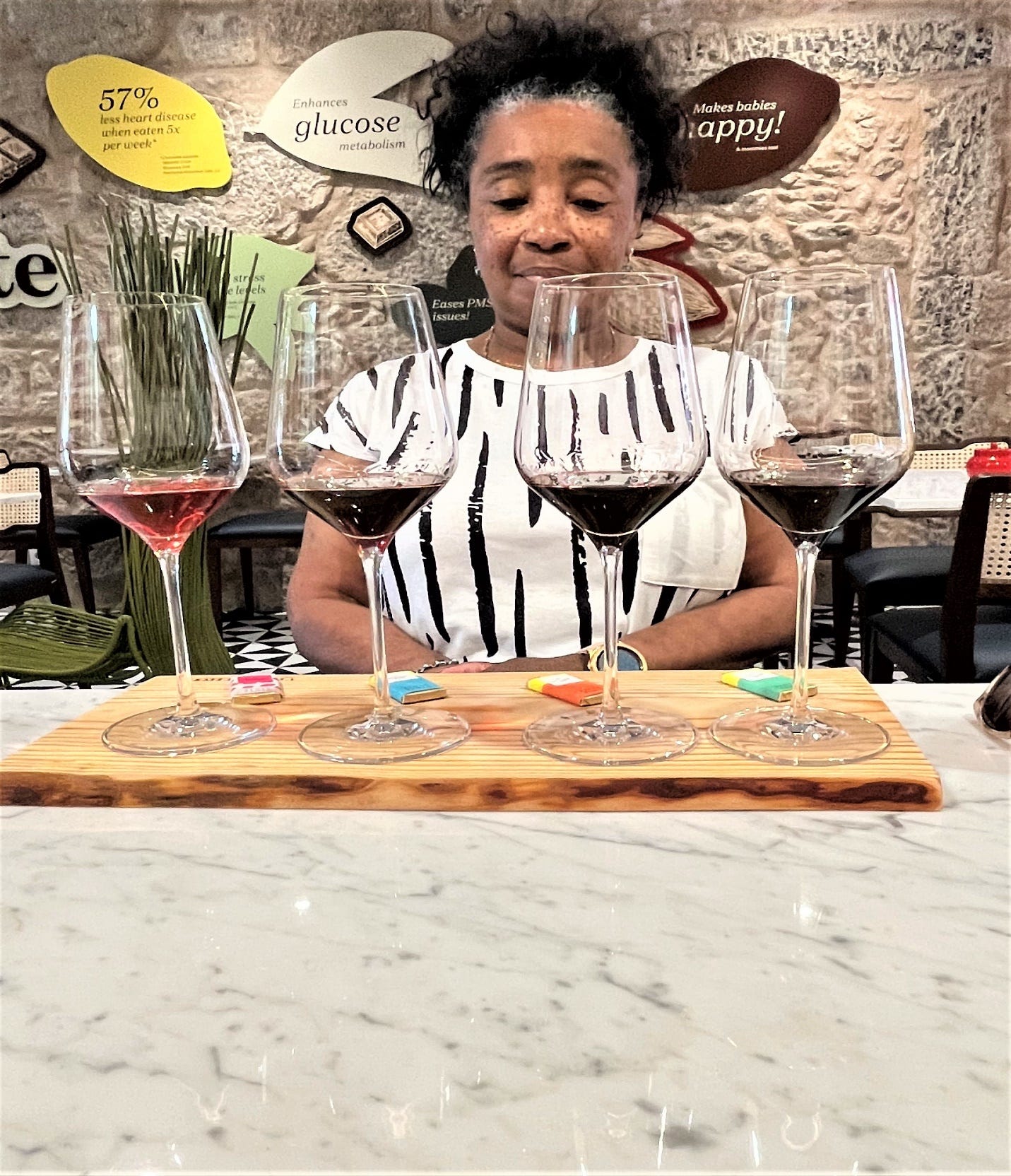 A person looking at wine glasses

Description automatically generated