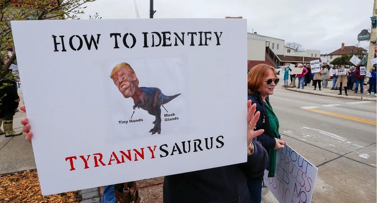 A group of people holding a sign

AI-generated content may be incorrect.
