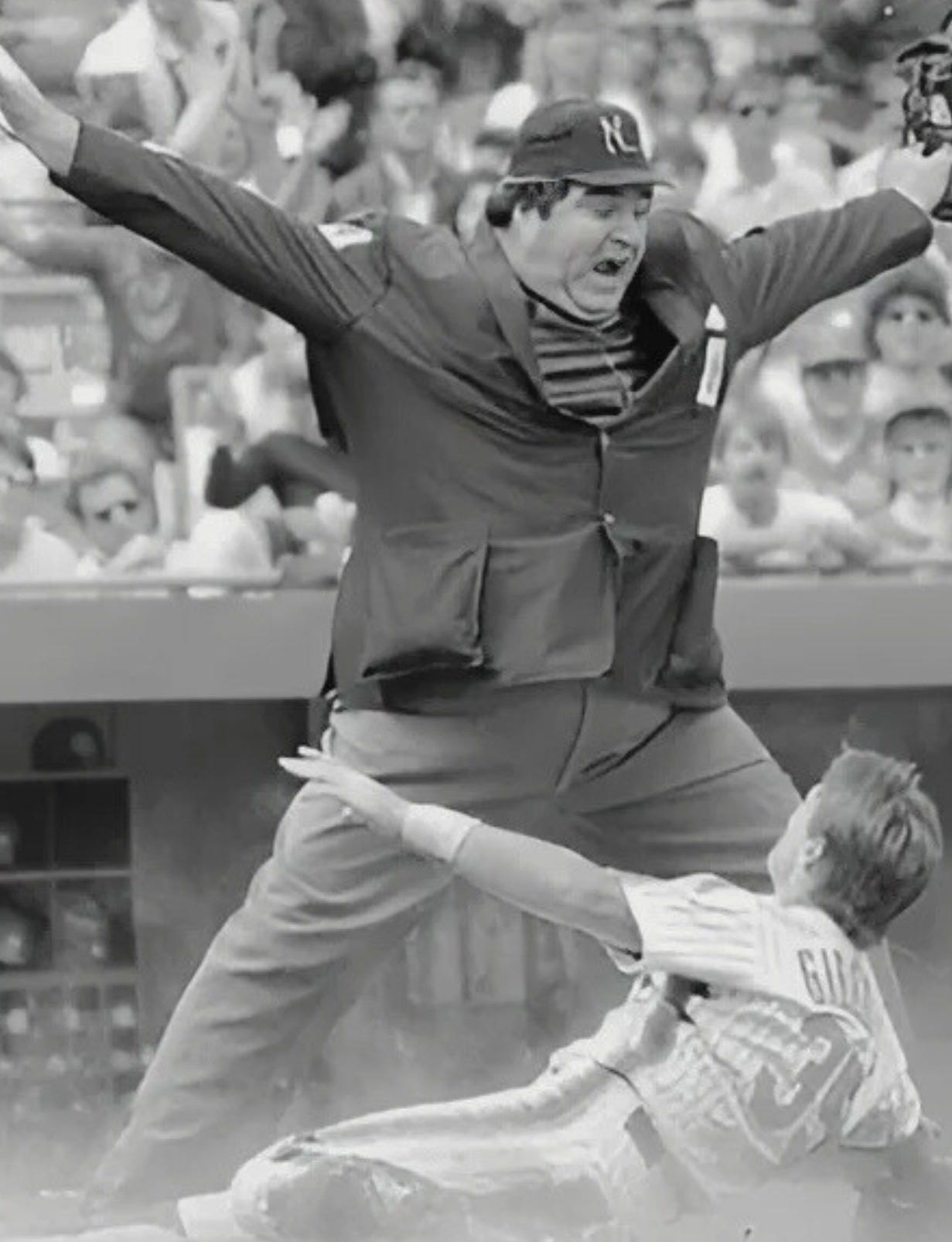 John McScherry signals a sliding player is safe at home plate.