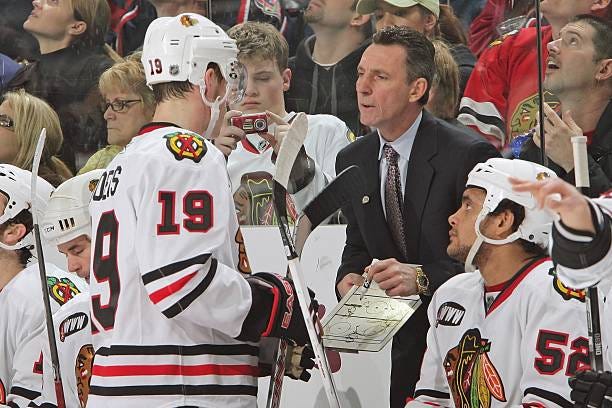 Chicago Blackhawks Head Coach Denis Savard offers instruction to Jonathan Toews of the Blackhawks during a game against the Columbus Blue Jackets on...