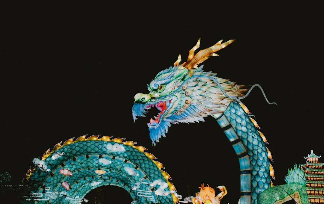 a dragon statue is lit up at night