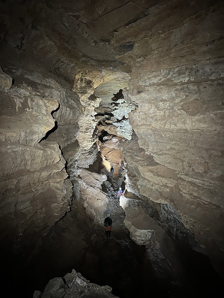 3 cavers in massive canyon passage 3 cavers in massive canyon passage