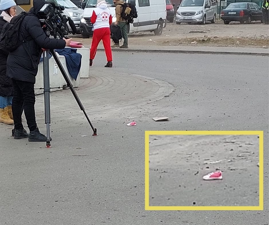 Cameraman at the Ukranian border. A pink shoe is put in the ground in order to create an artificial set