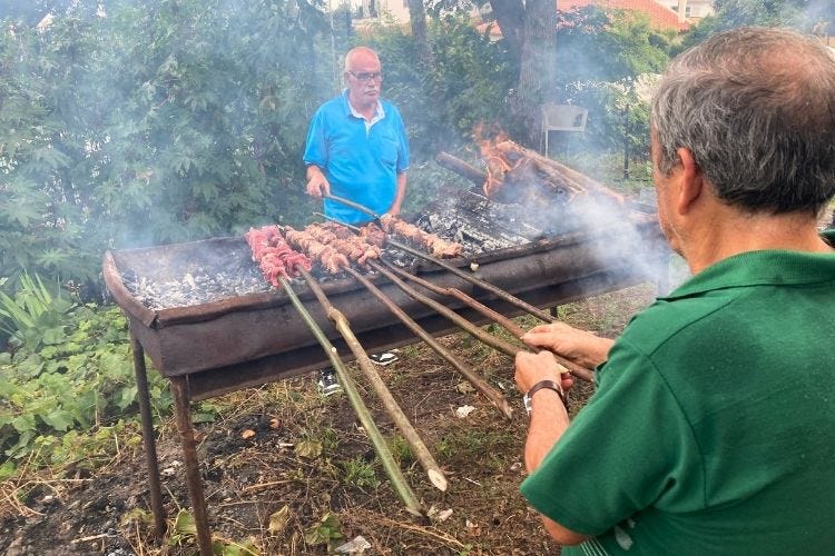 Preparing espetada over an open flame