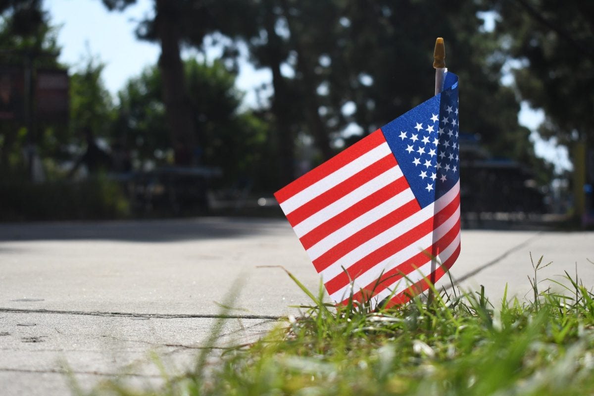 A flag stands near the area where Turning Point USA tabled briefly during Club Rush on Wednesday, Sept. 10. The organization was seen setting up before Club Rush's 11 a.m. start time. However, the organization left around noon, about an hour after TPUSA co-founder Charlie Kirk was shot. (Nikki Yunker | The Union)