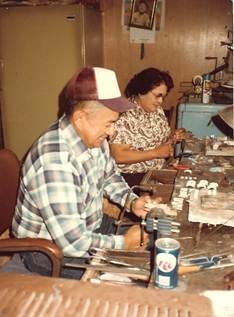 A person and person working on a table

AI-generated content may be incorrect.