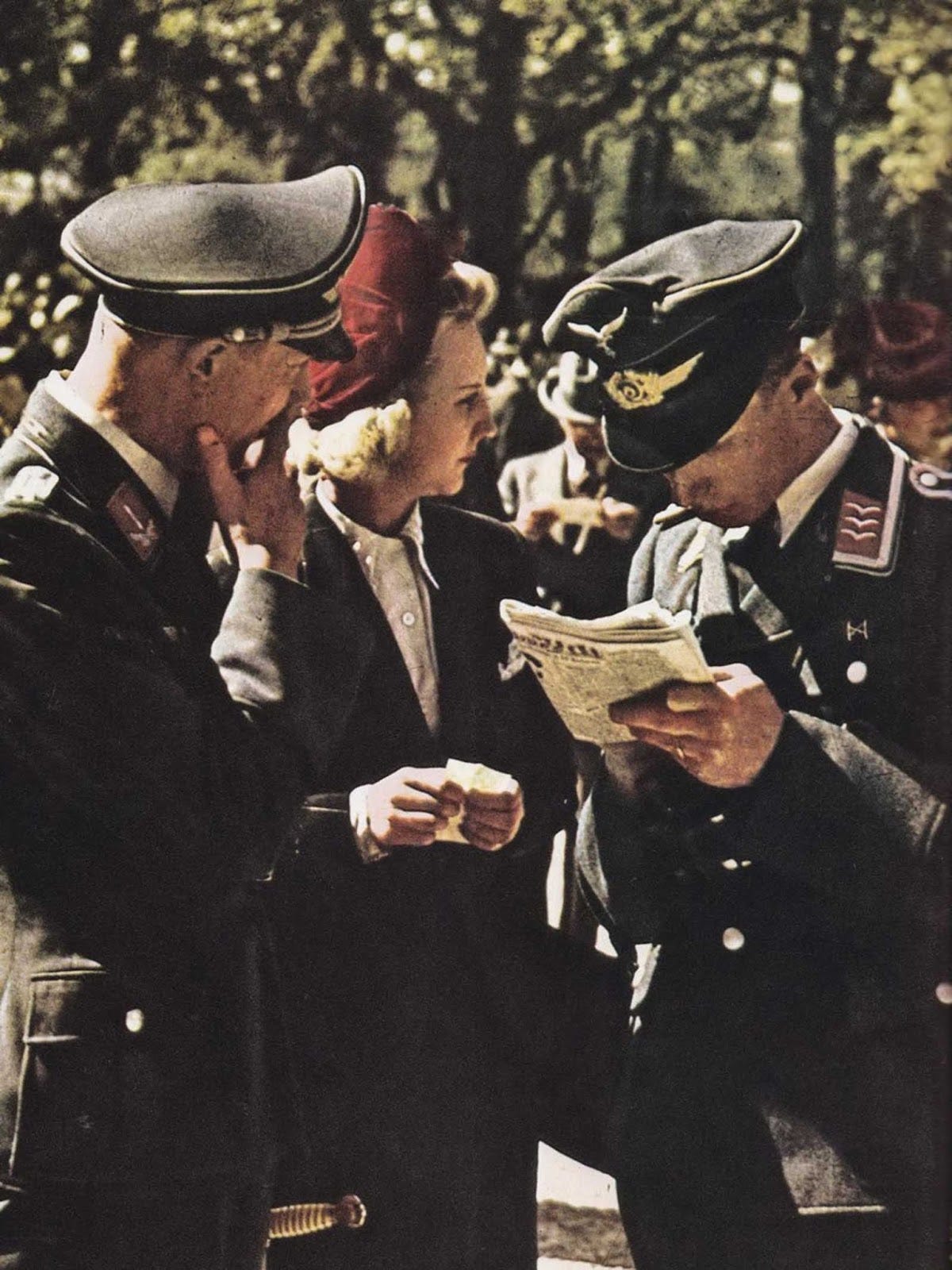 German officers conversing with a blonde woman, a familiar scene in occupied territories. German officers conversing with a blonde woman, a familiar scene in occupied territories.